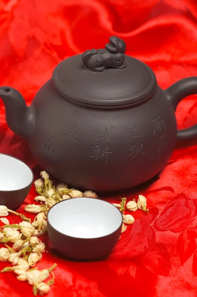 Jasmine tea over red silk — Stock Photo, Image