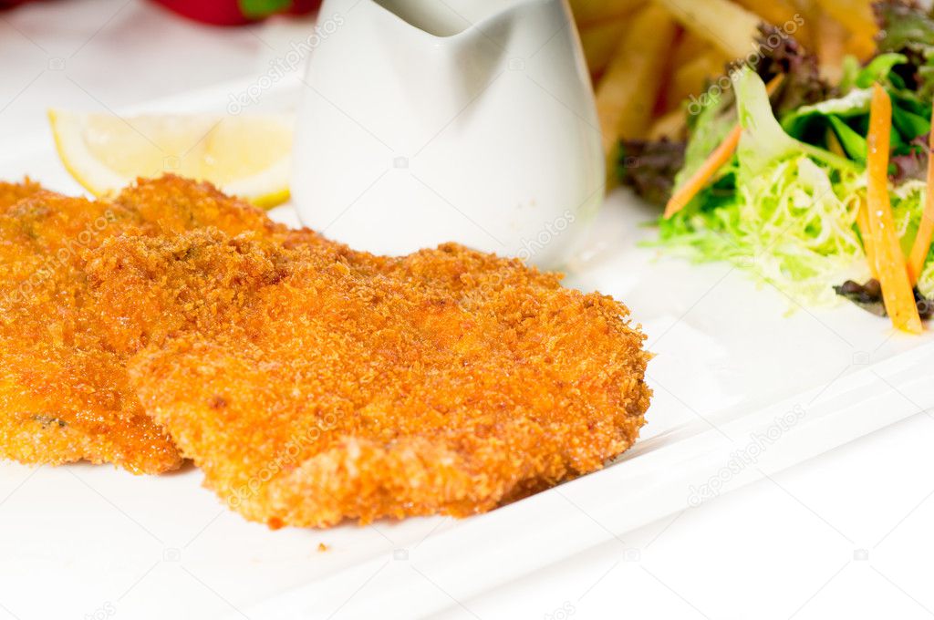 Classic Milanese veal cutlets and vegetables