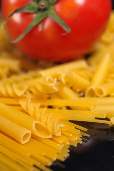 Stock image Italian pasta selection and tomato over black