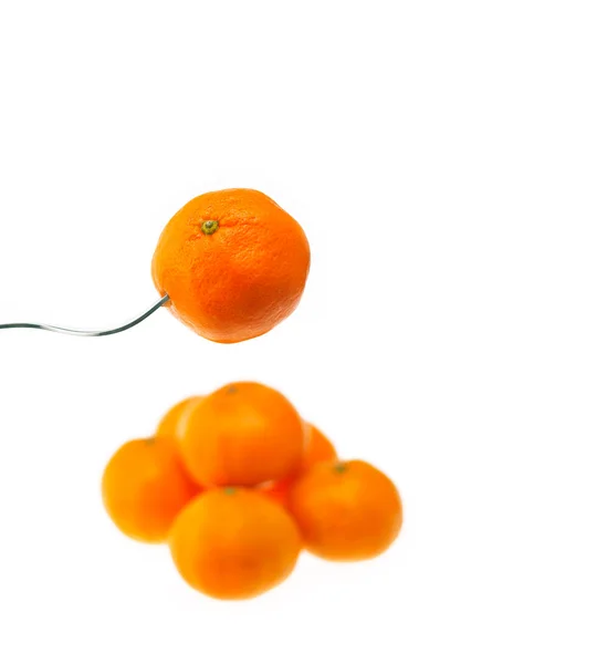 Orange mandarin tangerine on fork over white — Stock Photo, Image
