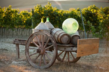 A cart loaded with wine bottles clipart