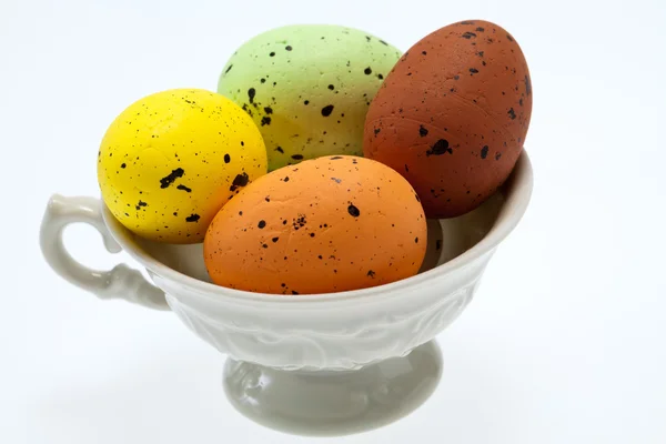 Colorful easter eggs in white cup — Stock Photo, Image