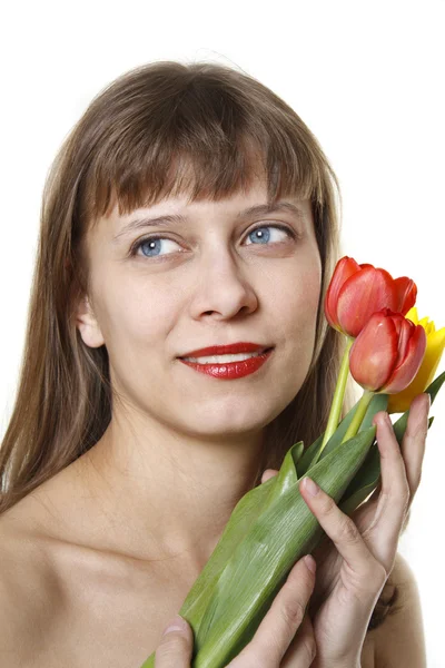 Das Mädchen hält Tulpen — Stockfoto
