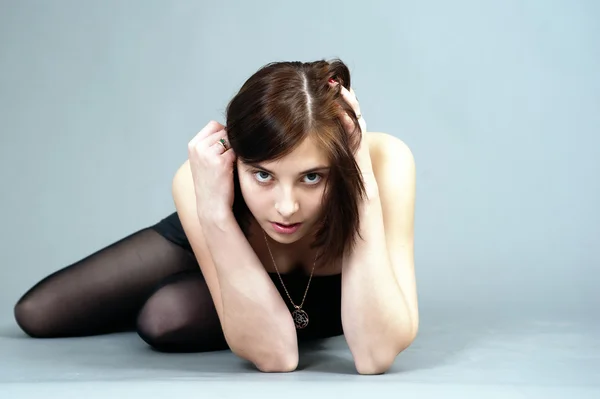 A girl sits in a studio Stock Image