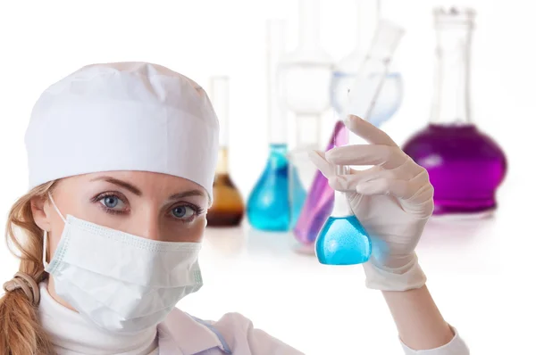 Scientist woman in lab coat with chemical glassware — Stock Photo, Image