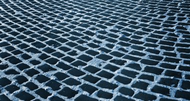 Close up shot of a cobblestone alley in winter time clipart