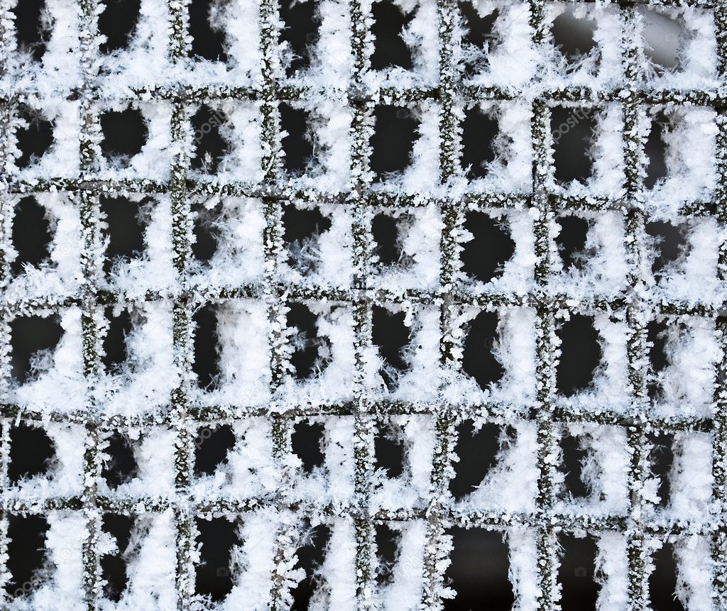 Texture of metal mesh, frozen in ice and snow.
