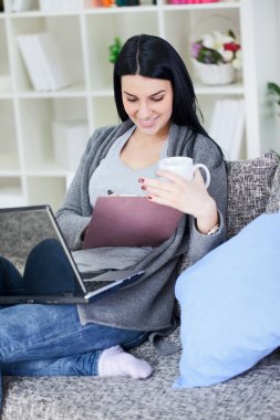 Young woman works on the laptop clipart