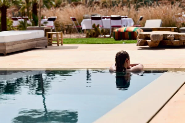 Mulher relaxante em uma piscina — Fotografia de Stock