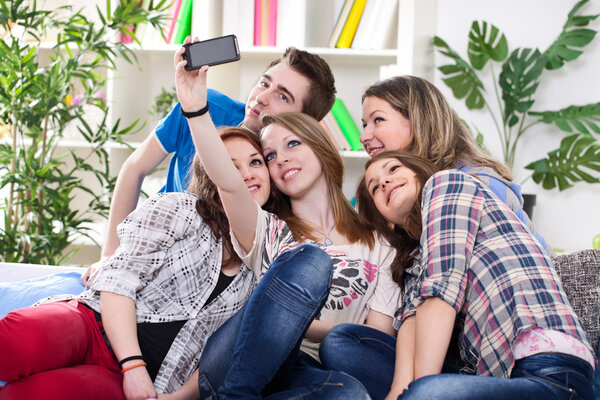 Teenagers taking group photo