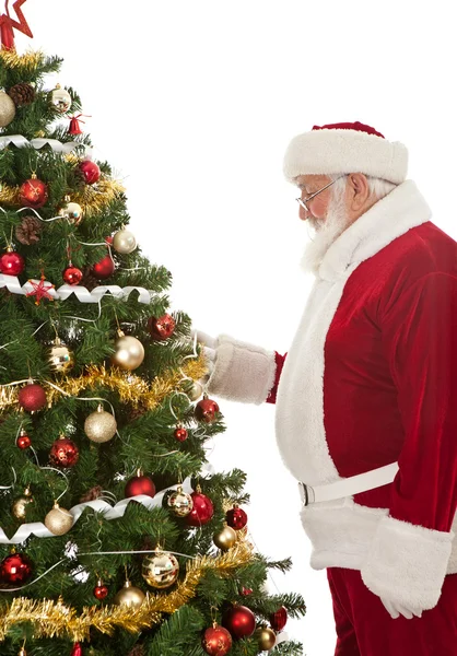 Santa decorating Christmas tree — Stock Photo, Image