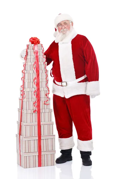 Weihnachtsmann mit großem Stapel Geschenke — Stockfoto