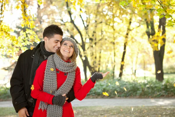 Paar genießt die fallenden Blätter — Stockfoto