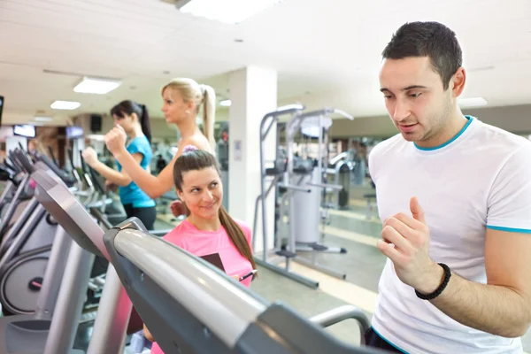 Trainer instructing man on treadmill — Stock Photo, Image