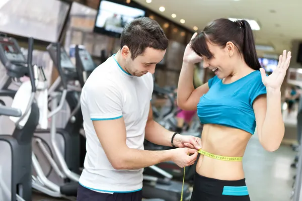 Woman in gym surprised with results — Stock Photo, Image
