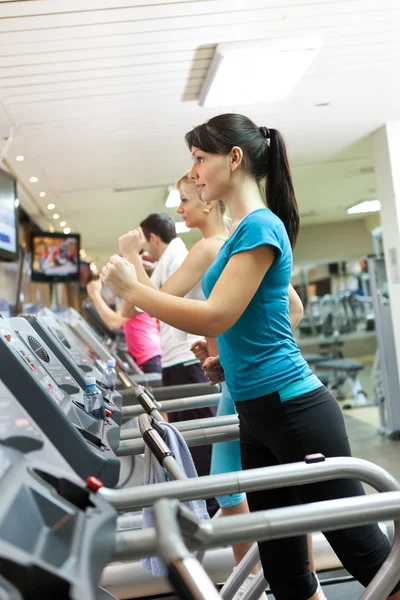 Young woman on treadmill — Stock Photo, Image