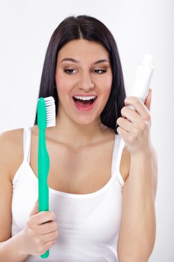 Smiling girl with toothbrush and tooth paste clipart