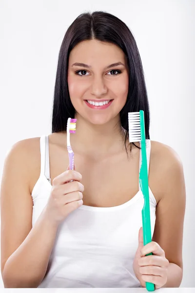 Funny girl with small and big toothbrush — Stock Photo, Image
