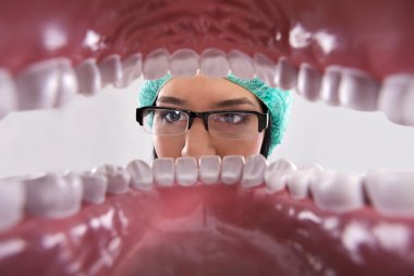 Dentist examining teeth clipart