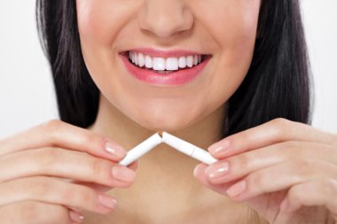 Woman breaking cigarette clipart