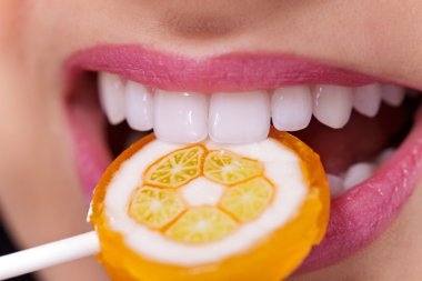 Healthy white teeth biting lollipop clipart