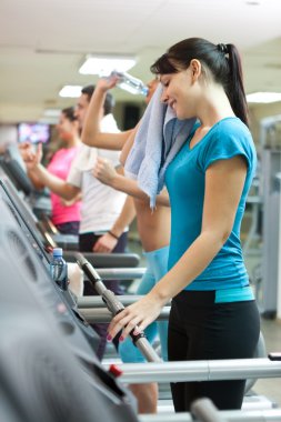 Sweating woman in gym clipart