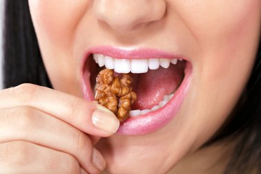 Female mouth with nut clipart