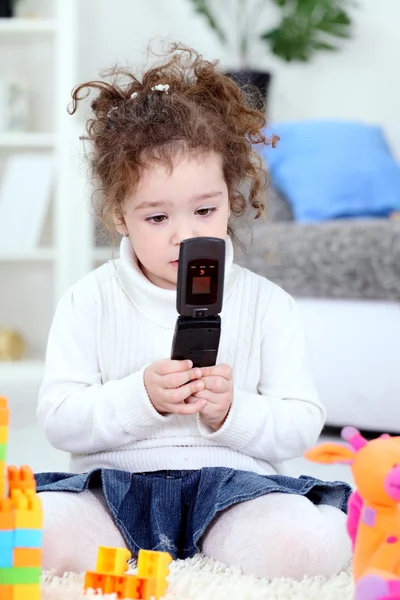 Baby girl playing with mobile phone — Stock Photo, Image