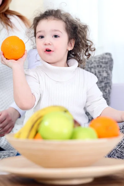 Little sweet girl holding orange — Stock Photo, Image