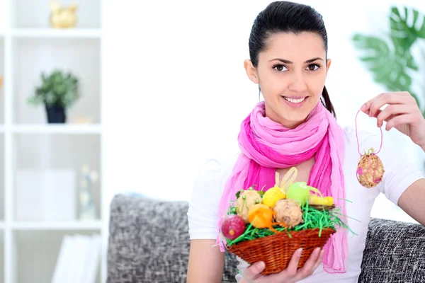 Woman holding a basket full of Easter eggs — Stock Photo, Image