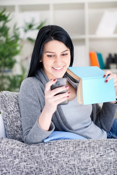 Vrouw met boek en telefoon — Stockfoto
