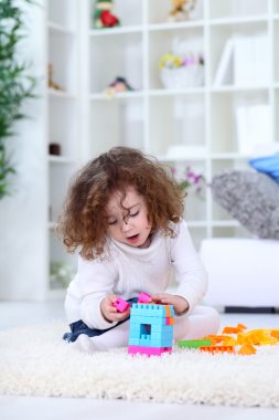 Little girl playing on floor clipart