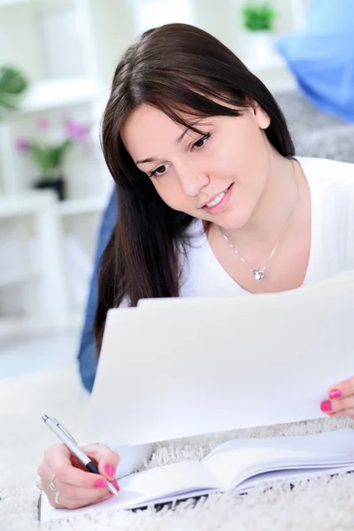 Smiling girl writing Stock Picture