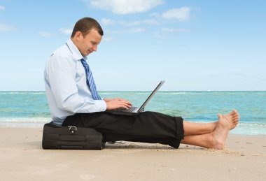 Businessman on the beach clipart