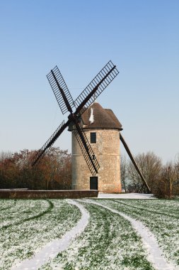 Traditional windmill in winter clipart
