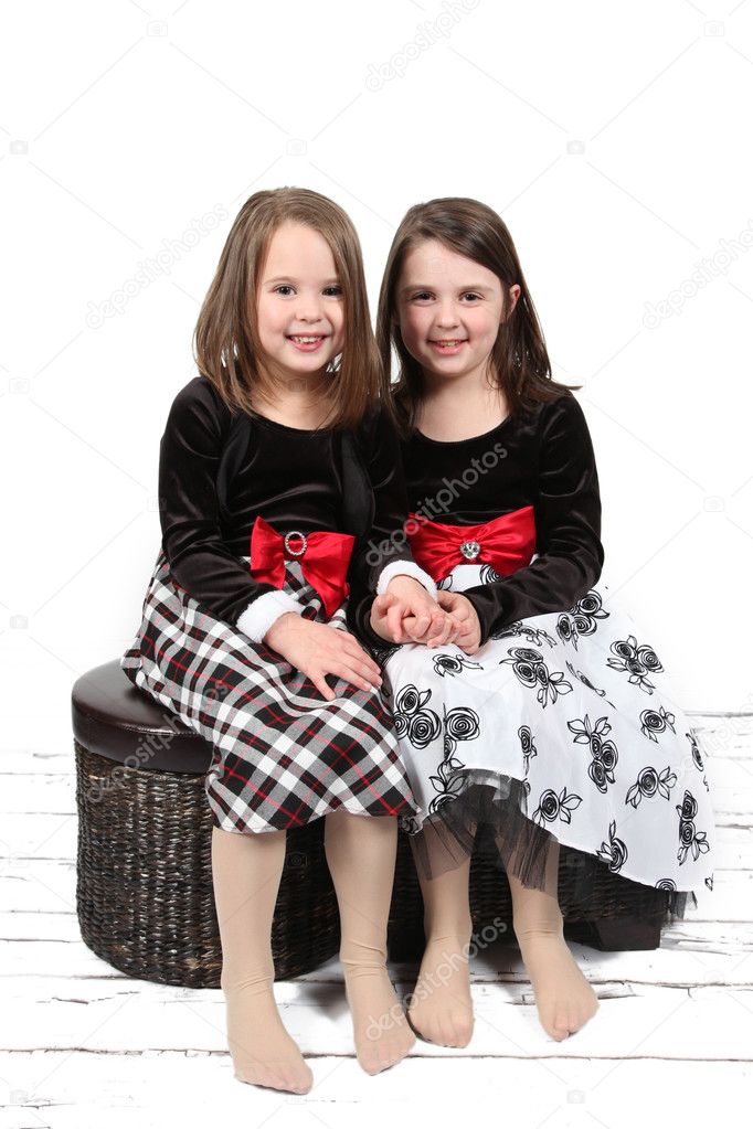 Adorable little sisters isolated on white background