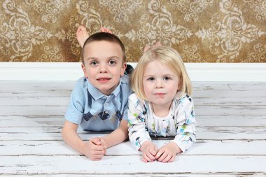 Adorable little brother and Sister on studio background clipart