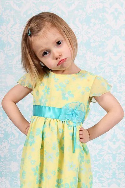 Adorable little girl making funny faces in studio — Stock Photo, Image