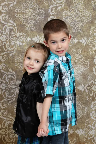 stock image Adorable little brother and Sister on studio background