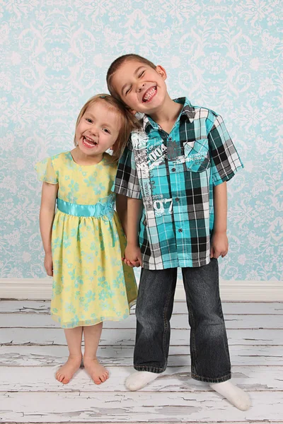 Adorable little brother and Sister on studio background Stock Photo
