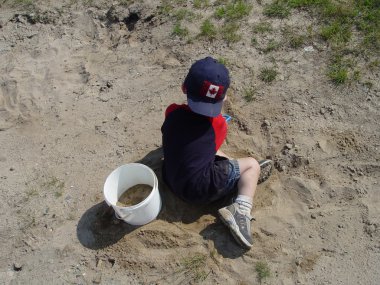 Boy playing in sand clipart