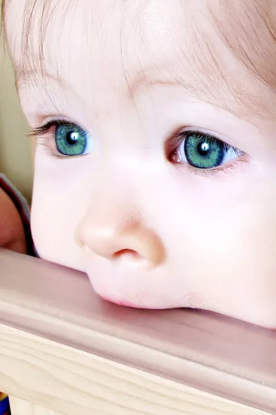Baby Biting on Crib - Closeup of green eyes — Stock Photo, Image