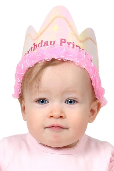 Baby pige med fødselsdag hat og hånd på luft - Stock-foto