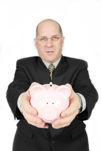 Homem de negócios segurando porquinho banco — Fotografia de Stock