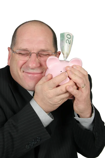Hombre de negocios abrazando Piggy Bank —  Fotos de Stock