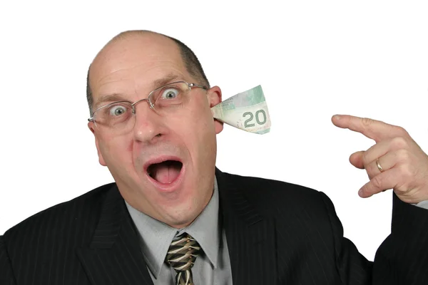 Affärsman med pengar som kommer från hans öron — Stockfoto