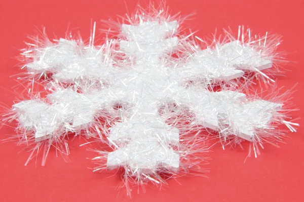 White snowflake on red background — Stock Photo, Image