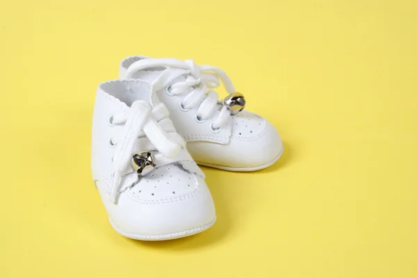 Baby Shoes Together on Yellow — Stock Photo, Image