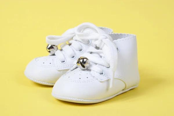 Baby Shoes Together on Yellow — Stock Photo, Image