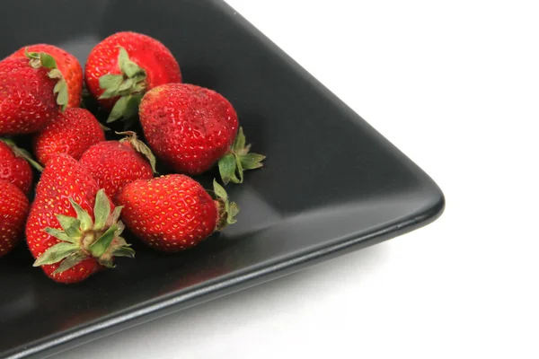 Strawberries on Black Plate over White — Stock Photo, Image